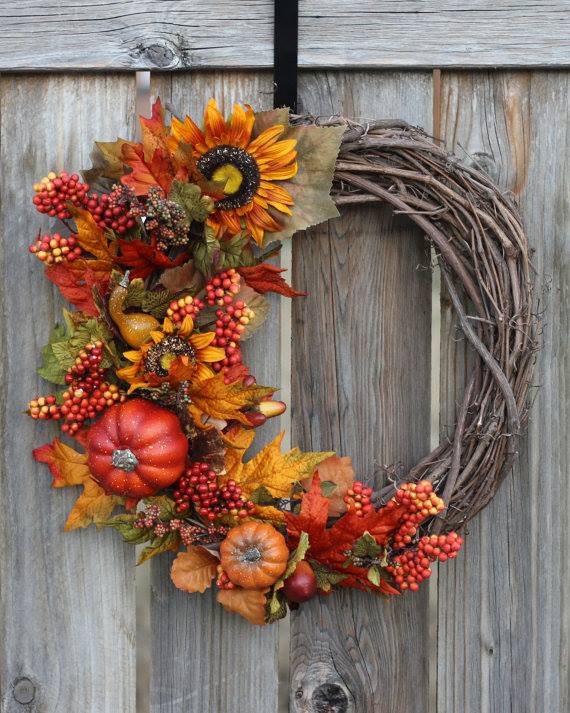 Photo of Fall wreath with grape vine, flowers and gourds.