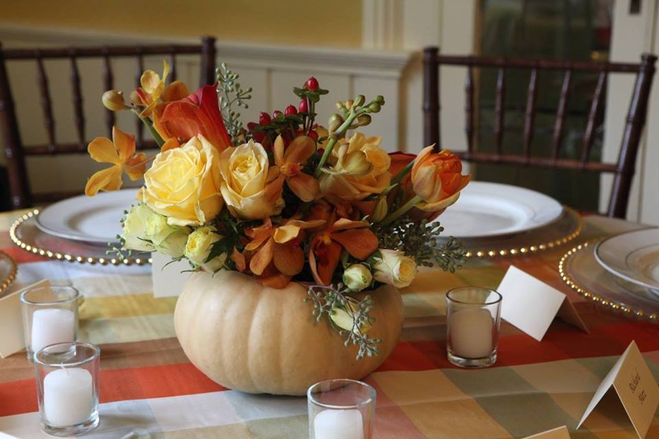 Photo of pumpkin with flower arrangement.