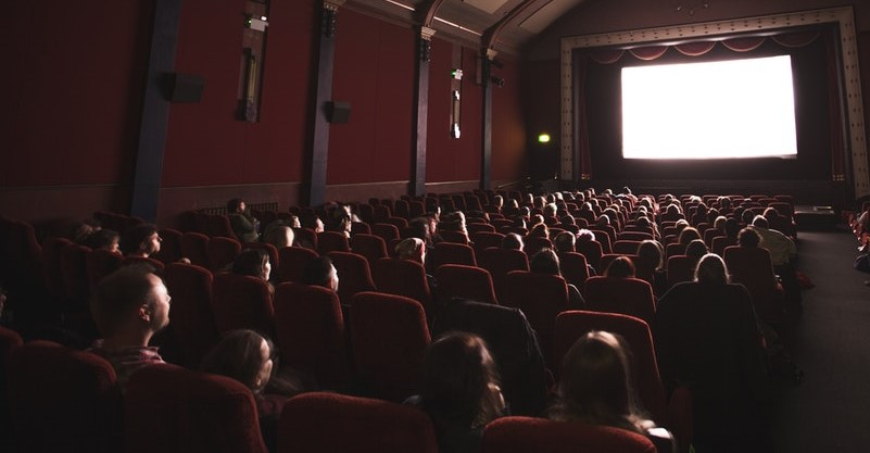 Photo of people in darkened theater.