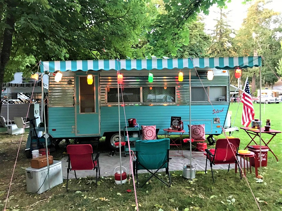 Photo of vintage trailer in park.