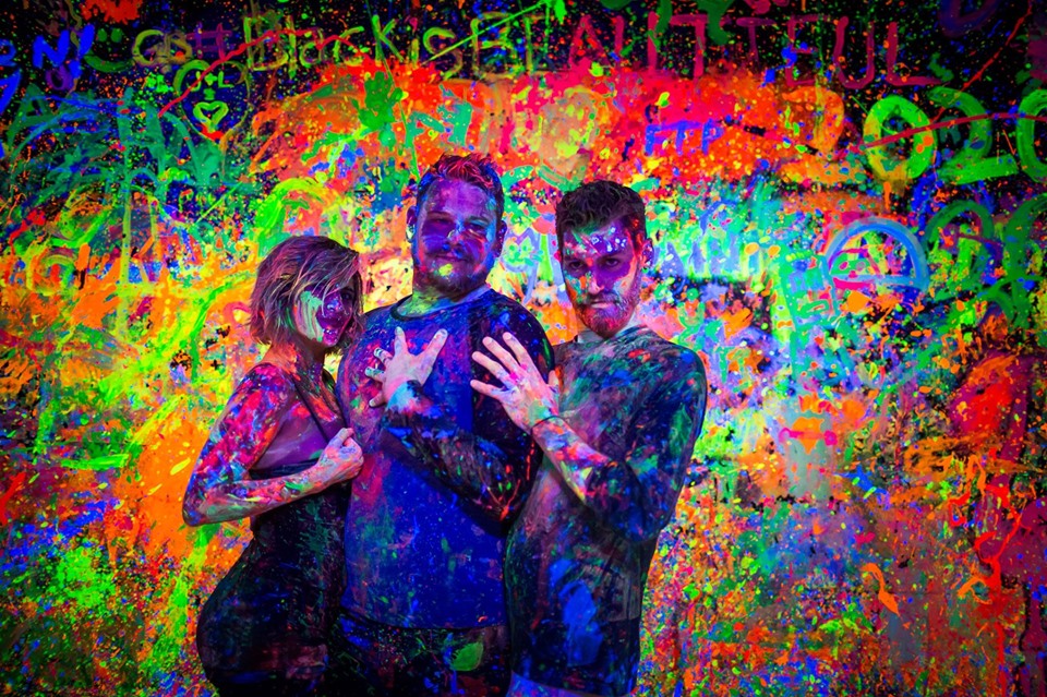 Photo of people covered in paint.