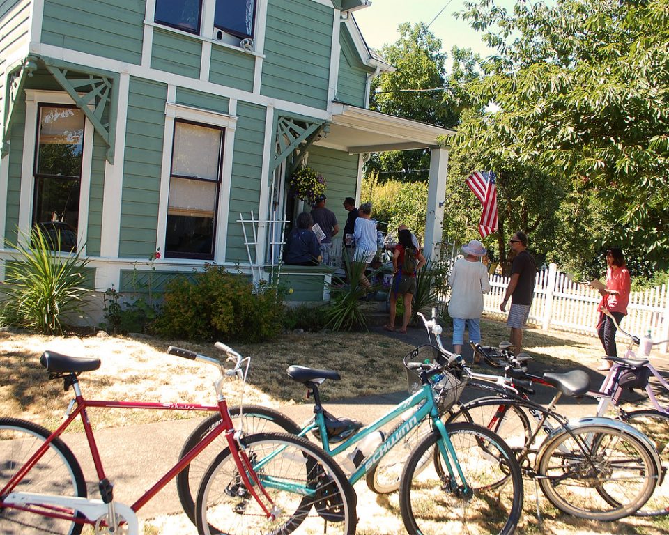 Image of historic home tour with vintage bicycles parked in front