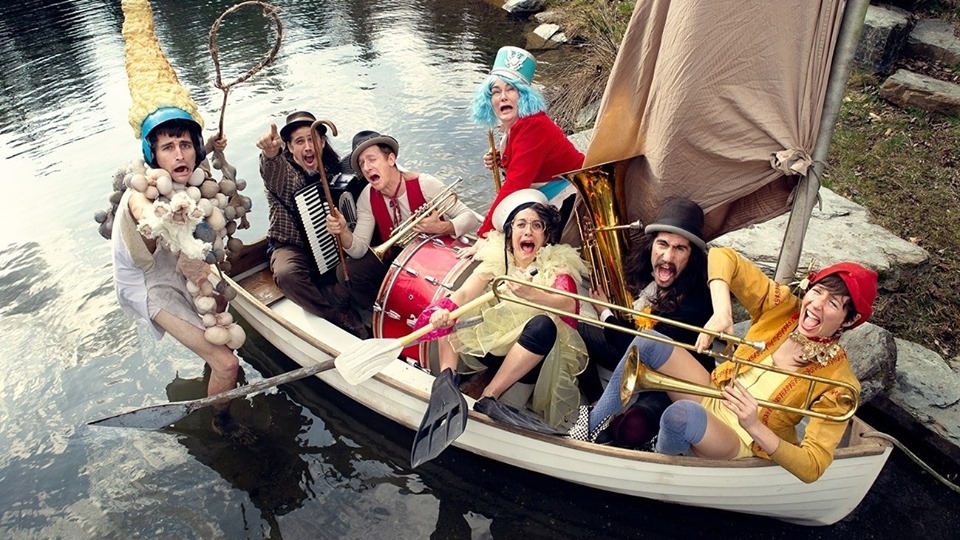 Photo of people in costume in a boat.