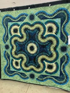 Photo of a quilt hanging up at the Willamette Valley Quilt Show