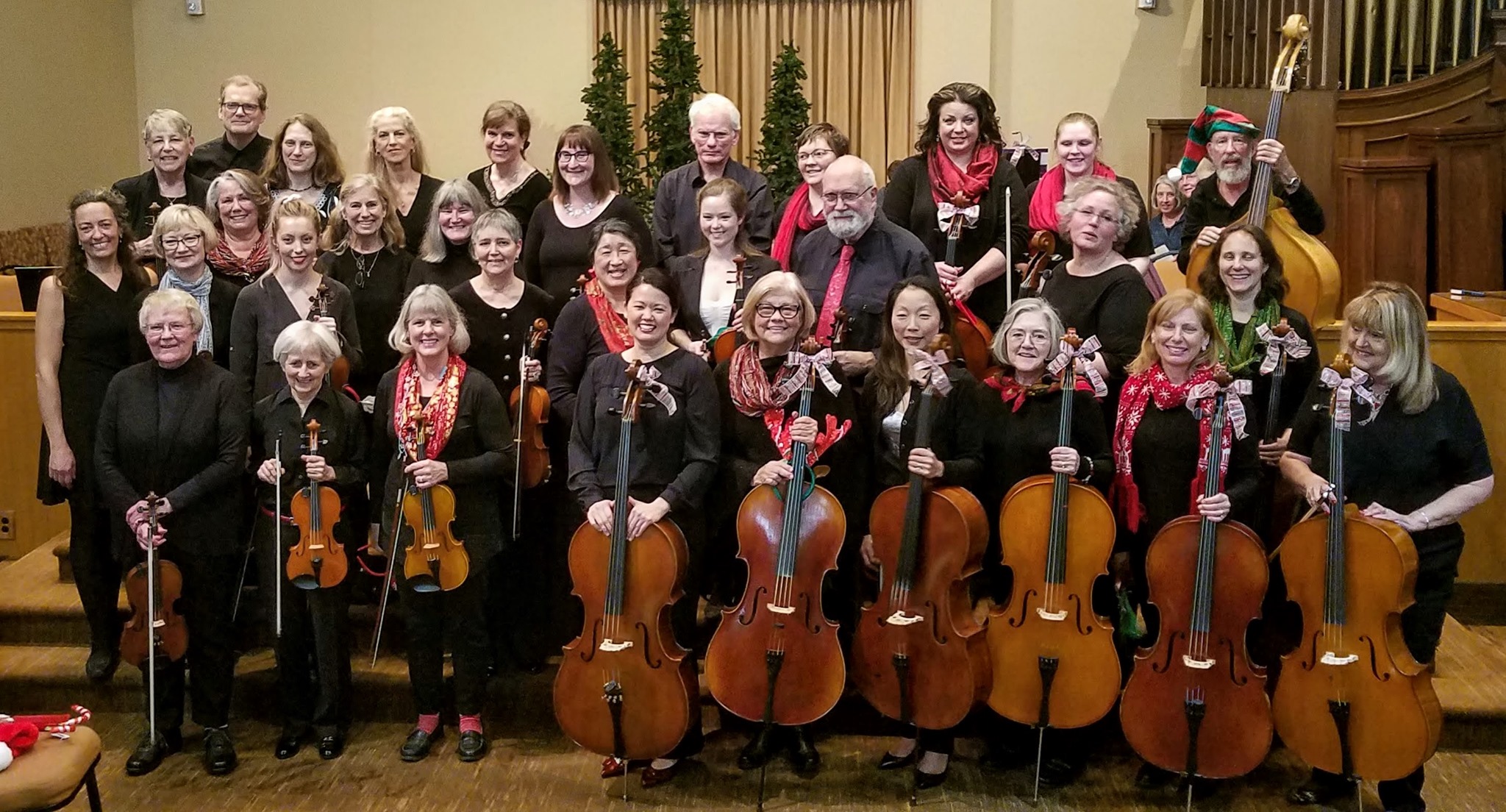 Photo of orchestra members in festive clothing.