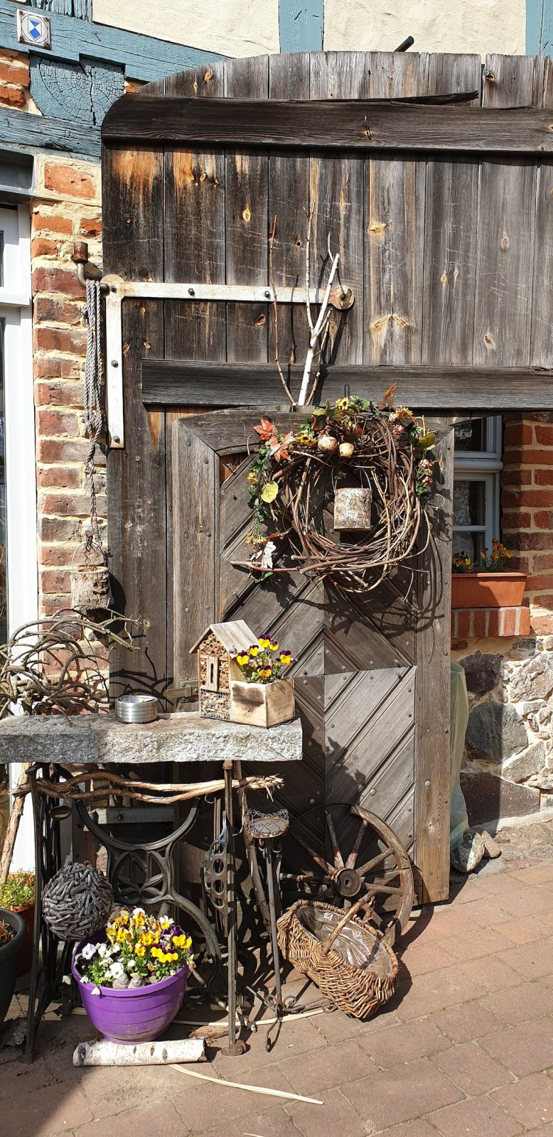 product display with birdhouse, flowers, wreaths, baskets