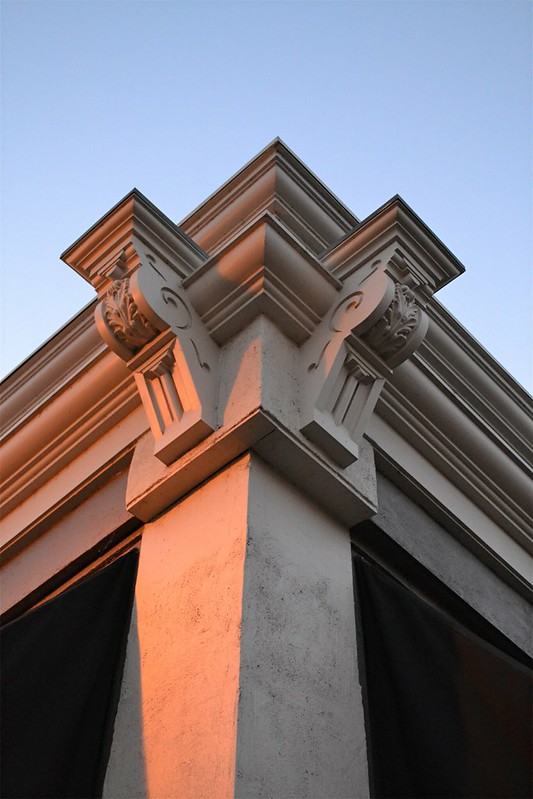 Corner of an building taken from below with decorative brackets