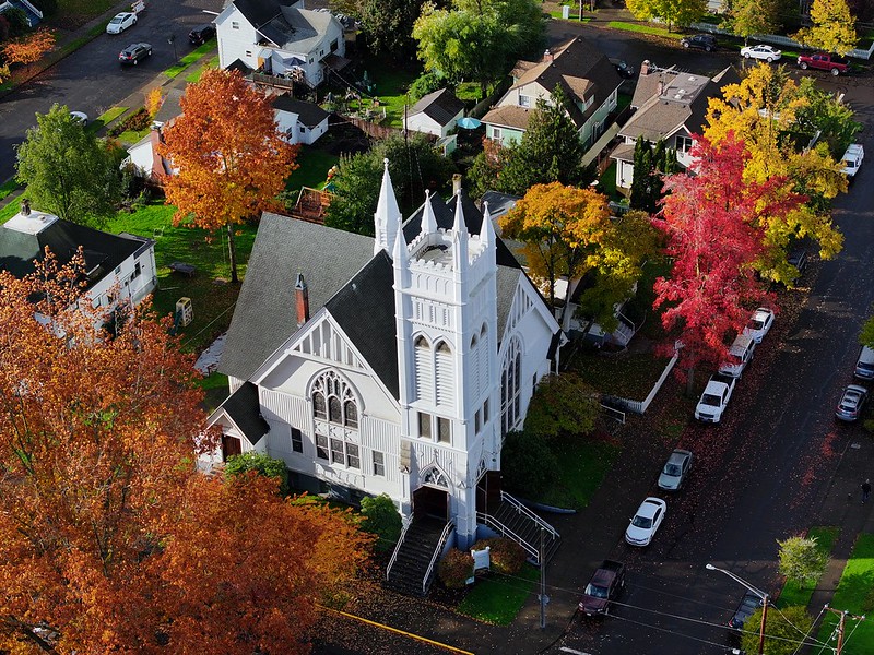 ariel view of a white church surrounded by fall trees